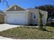 Charming single-Gathering home with a two-car garage and well-manicured lawn at 1370 Holodak Dr, Davenport, FL 33837