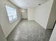 Bright living room with gray tile floors and large window at 1370 Holodak Dr, Davenport, FL 33837