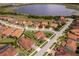 Aerial view of the home in neighborhood near lake at 1776 Bella Lago Dr, Clermont, FL 34711