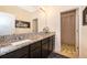 Granite-countered vanity in bathroom with tiled flooring and a shower with glass doors at 1776 Bella Lago Dr, Clermont, FL 34711