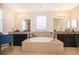 Luxurious bathroom featuring a soaking tub, dual vanities, and granite countertops at 1776 Bella Lago Dr, Clermont, FL 34711