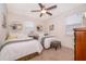 Cozy bedroom with two twin beds, stylish decor, and a ceiling fan for added comfort at 1776 Bella Lago Dr, Clermont, FL 34711