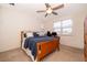 Bright bedroom with a wooden bed frame, ceiling fan, and a desk by the window at 1776 Bella Lago Dr, Clermont, FL 34711
