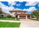 Beautiful two-story home with a red tile roof, a paver driveway, and a lush front yard at 1776 Bella Lago Dr, Clermont, FL 34711