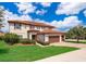 Elegant two-story home featuring a red tile roof, manicured lawn, and a spacious three-car garage at 1776 Bella Lago Dr, Clermont, FL 34711