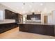 Spacious kitchen with granite countertops, dark wood cabinets, and stainless steel appliances at 1776 Bella Lago Dr, Clermont, FL 34711