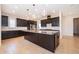 Spacious kitchen with granite countertops, dark wood cabinets, and stainless steel appliances at 1776 Bella Lago Dr, Clermont, FL 34711