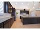 Spacious kitchen with granite countertops, dark wood cabinets, and stainless steel appliances at 1776 Bella Lago Dr, Clermont, FL 34711