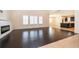 Spacious living room with dark wood floors, fireplace, and views of the kitchen at 1776 Bella Lago Dr, Clermont, FL 34711