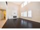 Elegant living room with high ceilings, a fireplace, and bright windows with shutters at 1776 Bella Lago Dr, Clermont, FL 34711