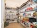 Walk-in pantry with wire shelving filled with ample storage and organization at 1776 Bella Lago Dr, Clermont, FL 34711