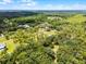 Wide aerial shot reveals the home's serene location amidst a dense forest landscape, offering seclusion at 1781 Terra Verde Ln, Chuluota, FL 32766