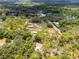 Panoramic aerial view showing a sprawling estate with carports nestled in a serene, wooded environment at 1781 Terra Verde Ln, Chuluota, FL 32766