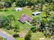 A high angle shot exhibits a home, including carports and expansive lawn space, set within a lush treed landscape at 1781 Terra Verde Ln, Chuluota, FL 32766