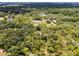 Serene setting highlighting a lovely dwelling encircled by a thriving forest landscape at 1781 Terra Verde Ln, Chuluota, FL 32766