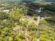 Scenic aerial view of the home, revealing its beautifully wooded surroundings and generous outdoor space at 1781 Terra Verde Ln, Chuluota, FL 32766