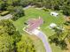 A serene aerial shot showcases the home's layout with a car port amidst its lush, green surroundings at 1781 Terra Verde Ln, Chuluota, FL 32766