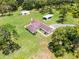 Aerial view of a residence featuring lush landscaping, outbuildings and tree-lined surroundings at 1781 Terra Verde Ln, Chuluota, FL 32766