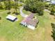 An aerial view of a serene estate showcasing a spacious home and manicured green landscape at 1781 Terra Verde Ln, Chuluota, FL 32766