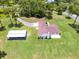 Aerial view of a sprawling property with a large home, separate barn, and spacious yard at 1781 Terra Verde Ln, Chuluota, FL 32766