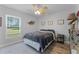 Inviting bedroom with a ceiling fan, side table, and a view of the backyard at 1781 Terra Verde Ln, Chuluota, FL 32766