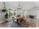 Charming dining space with rustic table, modern chandelier, and views of the outdoors at 1781 Terra Verde Ln, Chuluota, FL 32766