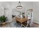 Bright dining room featuring a wood table with seating for four and an elegant chandelier at 1781 Terra Verde Ln, Chuluota, FL 32766
