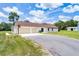 View of the house and long driveway with a basketball hoop and a well-manicured lawn at 1781 Terra Verde Ln, Chuluota, FL 32766