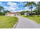 Exterior view of the property with a long driveway and spacious manicured front lawn at 1781 Terra Verde Ln, Chuluota, FL 32766