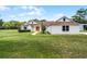 Beautiful home with meticulous lawn, complemented by mature trees and fresh landscaping at 1781 Terra Verde Ln, Chuluota, FL 32766