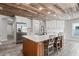Charming kitchen featuring a wood-paneled ceiling, island with seating, and stainless steel appliances at 1781 Terra Verde Ln, Chuluota, FL 32766
