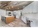 Charming kitchen featuring a wood-paneled ceiling, island with seating, and stainless steel appliances at 1781 Terra Verde Ln, Chuluota, FL 32766