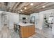 Charming kitchen featuring a wood-paneled ceiling, island with seating, and stainless steel appliances at 1781 Terra Verde Ln, Chuluota, FL 32766