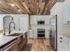 Bright kitchen featuring stainless steel appliances, a farmhouse sink, and a rustic wood ceiling at 1781 Terra Verde Ln, Chuluota, FL 32766