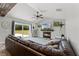 Inviting living room with a fireplace, large sliding glass doors, and a comfortable, oversized leather sofa at 1781 Terra Verde Ln, Chuluota, FL 32766