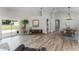 Open concept living area with wood-look floors, featuring lots of natural light at 1781 Terra Verde Ln, Chuluota, FL 32766