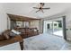 Spacious living room with wood ceiling accent, oversized leather sofa, and sliding glass doors to the patio at 1781 Terra Verde Ln, Chuluota, FL 32766