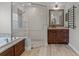 Beautiful main bathroom with a walk-in shower, separate tub, and dark wood cabinets at 1781 Terra Verde Ln, Chuluota, FL 32766