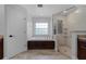 Bright main bathroom featuring a tub, walk-in shower, and dark wood vanity at 1781 Terra Verde Ln, Chuluota, FL 32766
