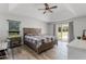 Spacious main bedroom with wood-look tile floors, ceiling fan, and sliding glass doors to the outside at 1781 Terra Verde Ln, Chuluota, FL 32766