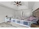 Large main bedroom featuring a tray ceiling, ceiling fan, and wood-look tile flooring at 1781 Terra Verde Ln, Chuluota, FL 32766