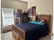 Bedroom showcasing a bright room and wooden bed frame filled with comic book decor at 2106 Congress Ln, St Cloud, FL 34769