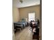 Bedroom featuring tile flooring, a desk, a window and a neutral color scheme providing a cozy space at 2106 Congress Ln, St Cloud, FL 34769