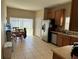 Eat in kitchen featuring stainless steel appliances, tile flooring, and sliding glass doors to the backyard at 2106 Congress Ln, St Cloud, FL 34769