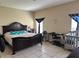 Main bedroom with neutral walls, a large bed, tile floors, and natural light creating a welcoming atmosphere at 2106 Congress Ln, St Cloud, FL 34769