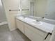 Bathroom featuring a double sink vanity with a large mirror and a view into the shower/toilet room at 2278 Tay Wes Dr, St Cloud, FL 34771