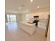 Modern kitchen featuring an island, stainless steel appliances and sliding glass doors to the patio at 2278 Tay Wes Dr, St Cloud, FL 34771