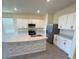 Well-lit kitchen with island, stainless steel appliances, and abundant counter space at 2278 Tay Wes Dr, St Cloud, FL 34771