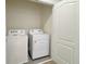 Bright laundry area features a white washer and dryer set next to a white door, offering convenience and functionality at 2278 Tay Wes Dr, St Cloud, FL 34771