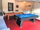 Recreation room with a pool table, air hockey table, laundry area, and ample space for activities at 2281 Royal Ridge Dr, Davenport, FL 33896